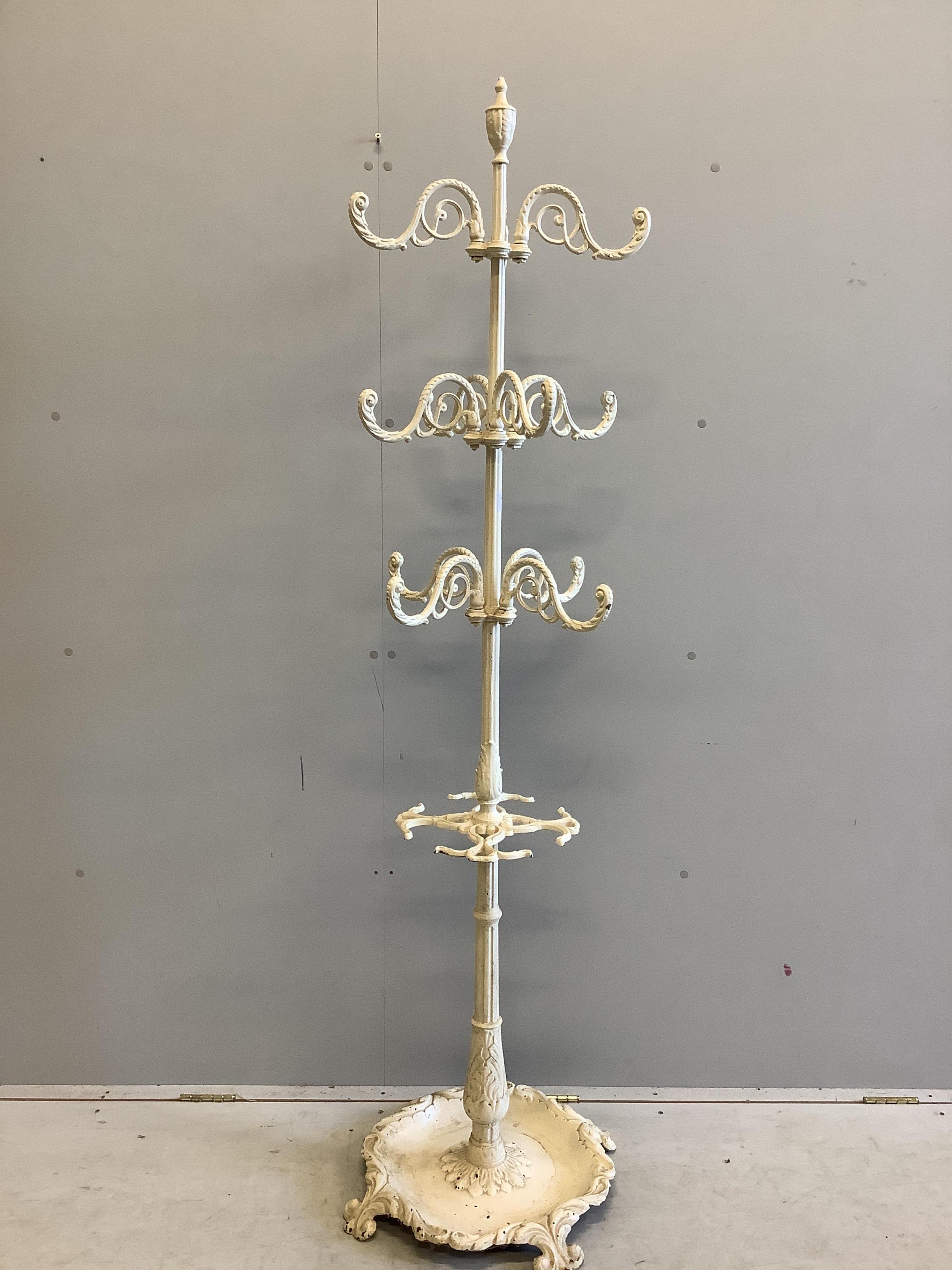 A Victorian tyle cast iron coat and stick stand, height 180cm. Condition - fair, one arm missing